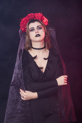 girl witch in a wreath of red roses - 303904237