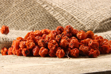 Dry fruits of hawthorn orange on a background of coarse fabric