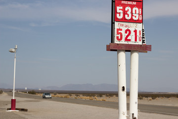 Vintage Gas Station with car in background on highway