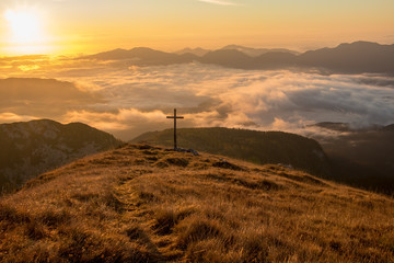 Mountain sunrise with big cross on Ogradi, Bohinj