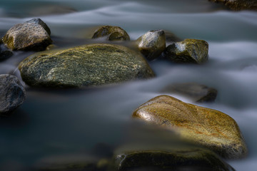 Big stones in mountain flowing stream