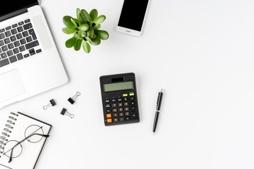 Modern office desktop with calculator and accessories on white background. Financial concept. Top...