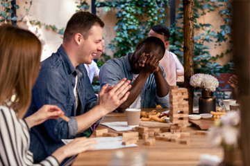 Breaking jenga tower and laughing with best friends at the cosy open air restaurant