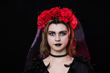 girl witch in a wreath of red roses