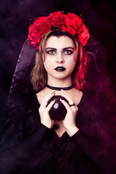 girl witch in a wreath of red roses