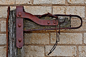 Old rusty metal brace with rivets from bygone era 