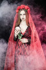 witch vampire girl in red dress with red veil - 303910630