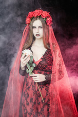 witch vampire girl in red dress with red veil - 303910656