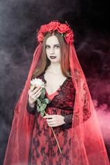 witch vampire girl in red dress with red veil - 303910666