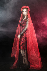 witch vampire girl in red dress with red veil - 303910824