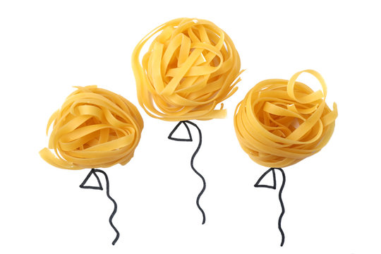 Balloons made with tagliatelle pasta on white background, top view