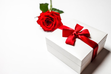 Concept of romantic gift with red rose and boxes with jewelry