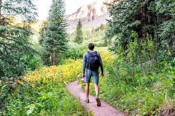 Man backpack walking on trail path to Ice lake in Silverton, Colorado in August 2019 summer morning...