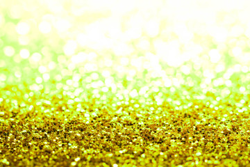 Obraz premium gold Sparkling Lights Festive background with texture. Abstract Christmas twinkled bright bokeh defocused and Falling stars. Winter Card or invitation 