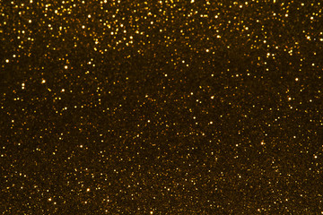 Fototapeta na wymiar gold Sparkling Lights Festive background with texture. Abstract Christmas twinkled bright bokeh defocused and Falling stars. Winter Card or invitation 