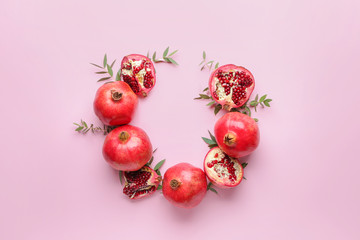 Composition with ripe juicy pomegranates on color background