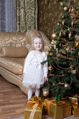 girl near a decorated Christmas tree