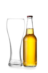 Bottle of fresh beer and empty glass on white background