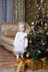 girl near a decorated Christmas tree