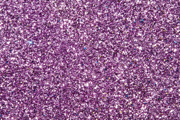 purple Sparkling Lights Festive background with texture. Abstract Christmas twinkled bright bokeh...