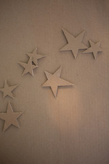Cardboard stars on a brown background. Eco-style