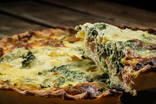 Traditional French cake. quiche with chard in white. Dark wood background. free space text.