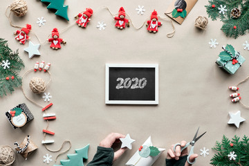 Creative handmade decor, zero waste Christmas frame for new year. Flat lay, top view on craft...