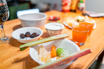 Sour foods sliced fruit vegetables serving setting on wooden table for breakfast with rhubarb, lemon, lime and kombucha juice glasses miracle berry tasting