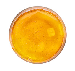 Orange slime with glitter in plastic container isolated on white, top view. Antistress toy