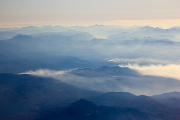 White clouds in blue sky. Aerial view from airplane.
