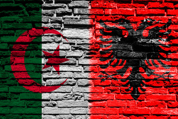 Flag of Albania and Algeria on brick wall