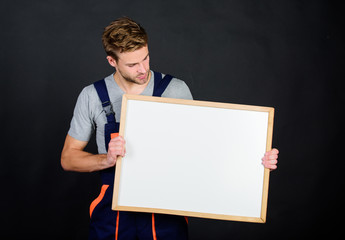 Handsome repairman. Man repairman builder work clothes. Plan repair work using blueprints or...