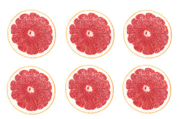 Top view of ripe fresh juicy round slices, pieces of grapefruit, red citrus fruit. Cut grapefruit, clipping path isolated on white background. Healthy vegan or vegetarian food concept. Vitamin C.