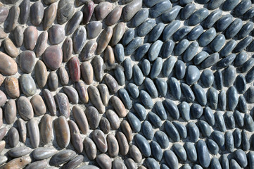 The sidewalk or wall of small pebbles lined with a pattern. Art Wallpaper, Abstract Background,