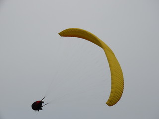 paraglider flight in cloudy day