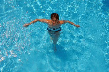 Top view of pool water with beautiful woman