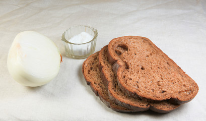 half onions salt and bread on the table