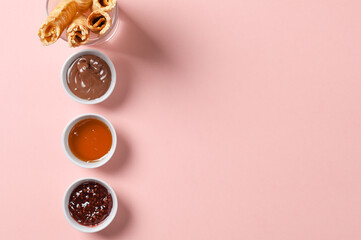 Wafer rolls with a sweet sauce. On a multicolored background. Minimalism