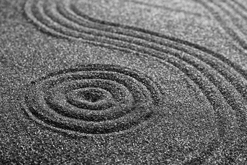 Fotobehang Stenen in het zand Pattern on decorative black sand, closeup. Zen and harmony
