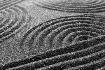 Pattern on decorative black sand, closeup. Zen and harmony
