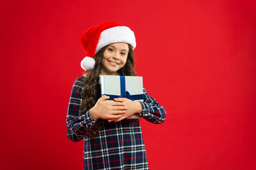 Happy winter holidays. Small girl. Present for Xmas. Childhood. Little girl child in santa red hat. New year party. Santa claus kid. Christmas shopping. Shopping Center