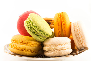 A Pile of Colorful Macaroons on a Plate Isolated on White Background