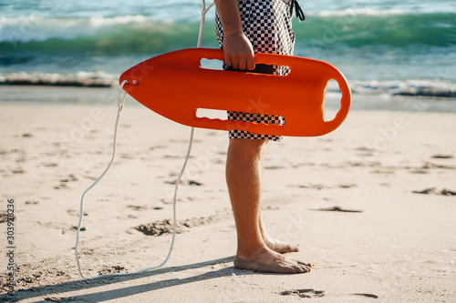male lifeguard running on the beach wall mural