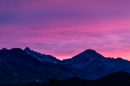 Aspen, Colorado colorful purple pink blue vivid vibrant sunset twilight with Snowmass mountain peak ridge closeup silhouette