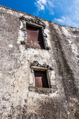 Fototapeta na wymiar Windows in the wall of a very ancient monastery