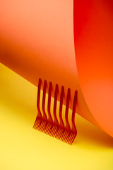 Abstract still life with red forks on a colored background