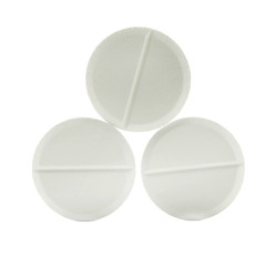 white round close-up pills macro isolated on white background