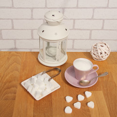 loose sugar in a tea cup with saucer, refined slices, sugar tongs, white coffee pot and interior...
