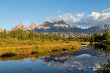 Fototapeta na wymiar A view of the Grand Teton mountains at sunrise with a reflection in the Snake river from Schwabacher