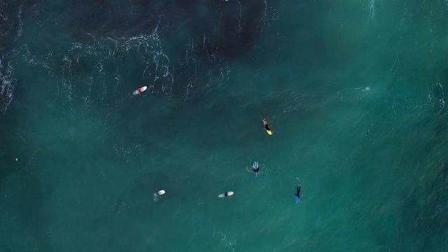 Aerial view of surfers on surfboard in the sea. Ghajn Tuffieha beach. Europe. Malta island